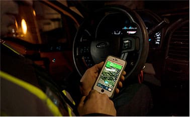 Man holding phone in drivers seat